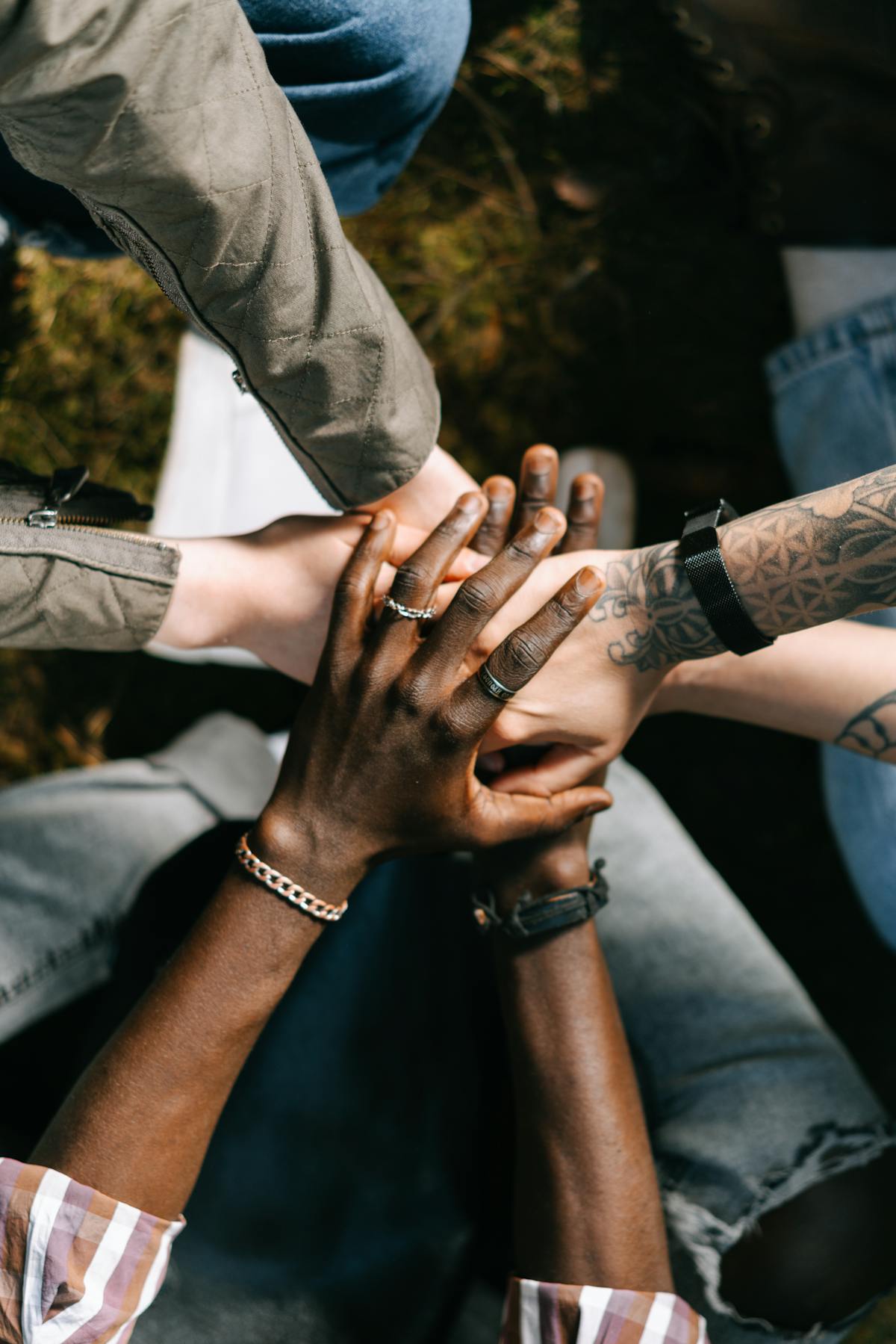 Family hands meeting in a circle — community made visible